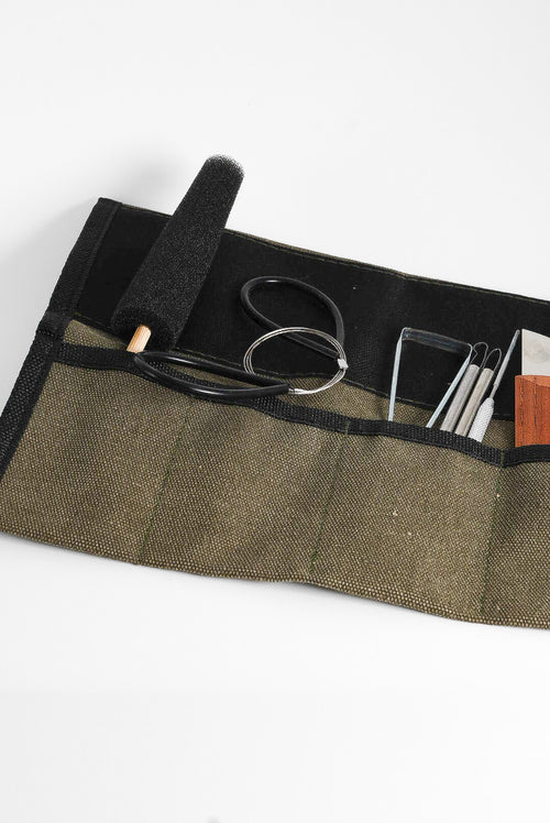 The GLOST Beginner Essentials tool set with the khaki canvas tool roll.