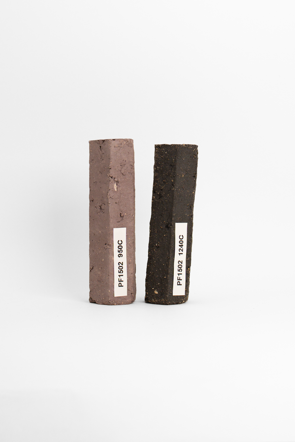 PF660 test tiles side by side, dull plum at 950C and coarse speckled black at 1240C