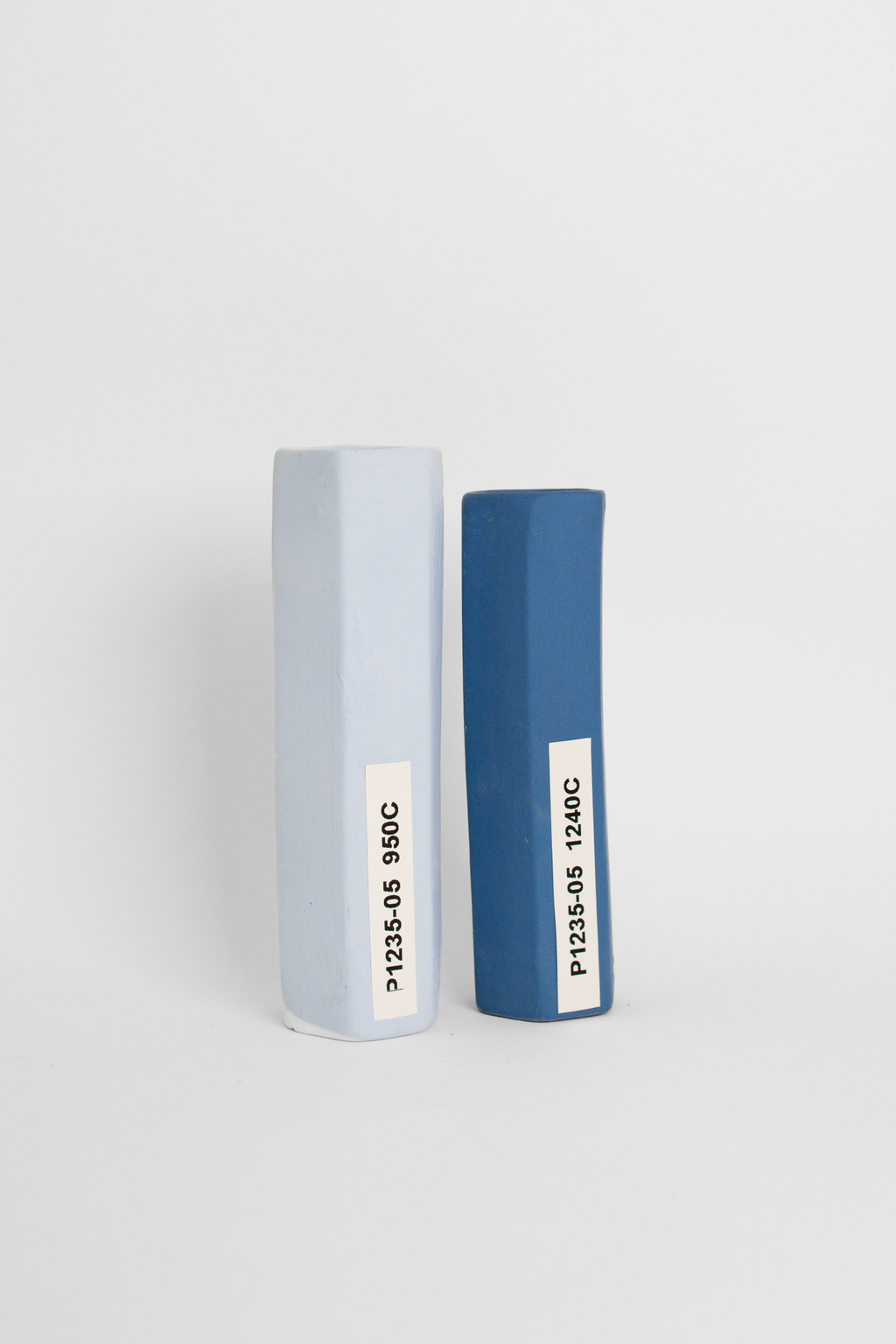 Sapphire test tiles side by side, pale blue-grey at 950C and deep blue at 1240C