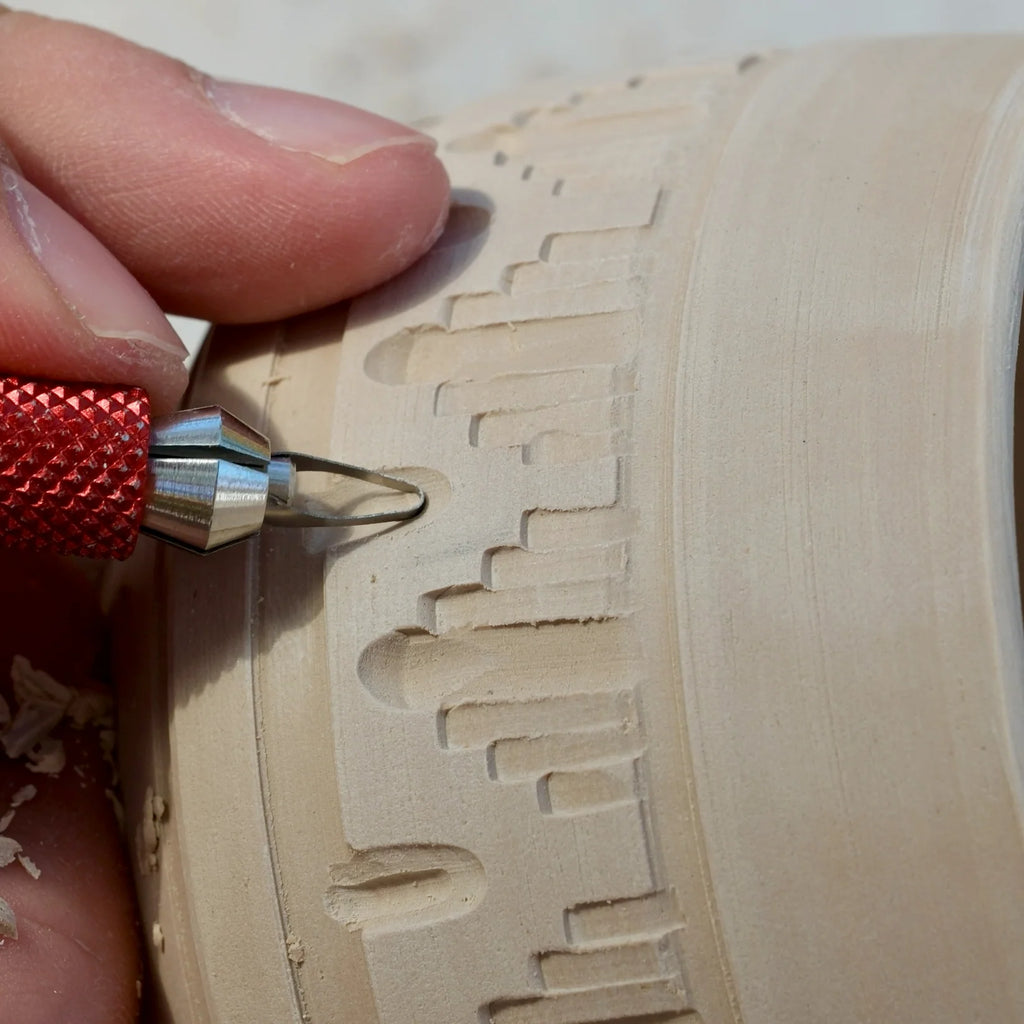 Carving a stepped geometric pattern into a pot with a BuschKraft Dragonfly blade