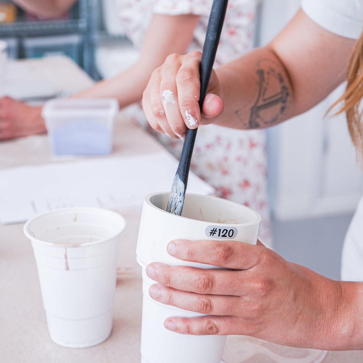Participants learning the fundamentals of glaze making during a three-day workshop, with expert guidance and all materials included.