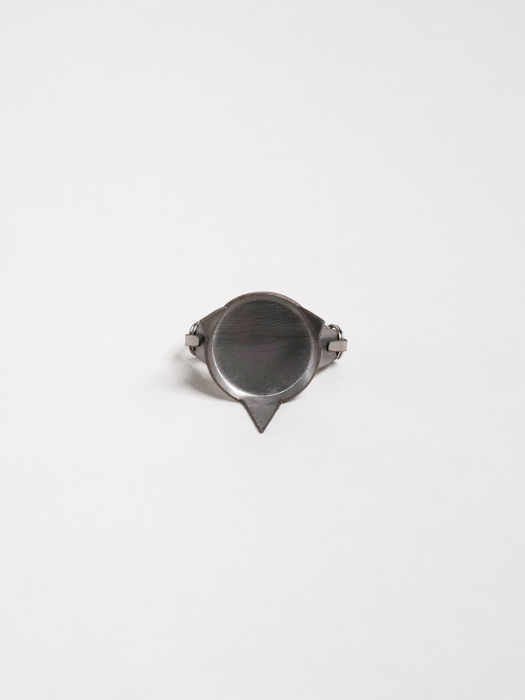 Hand displaying a pair of compact metal tools used to suspend lightweight ceramic pieces for glaze dipping.