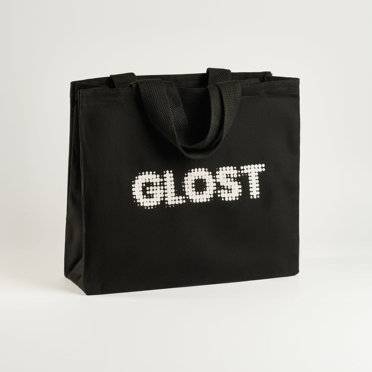 GLOST Tote Bag is crafted in the UK from high-quality cotton. This sturdy bag is designed to withstand the demands of the pottery studio, making it ideal for carrying glazes, tools, and other essentials. Featuring the bold GLOST logo, it combines durability with style, offering a practical solution for ceramic artists on the go.