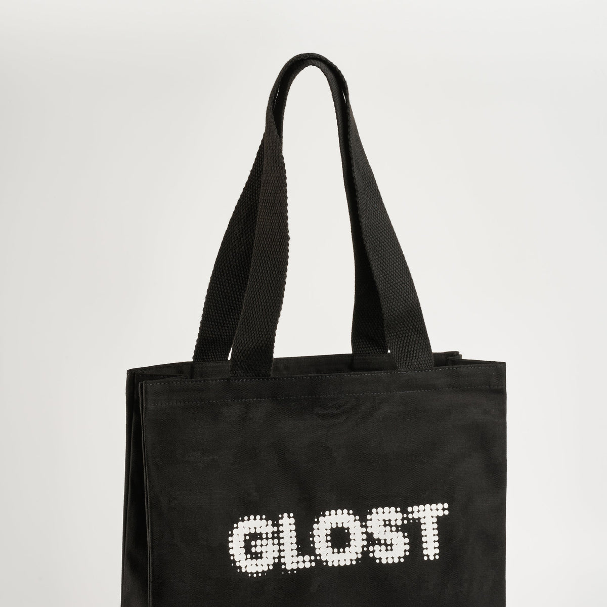GLOST black cotton tote bag with the logo printed in white