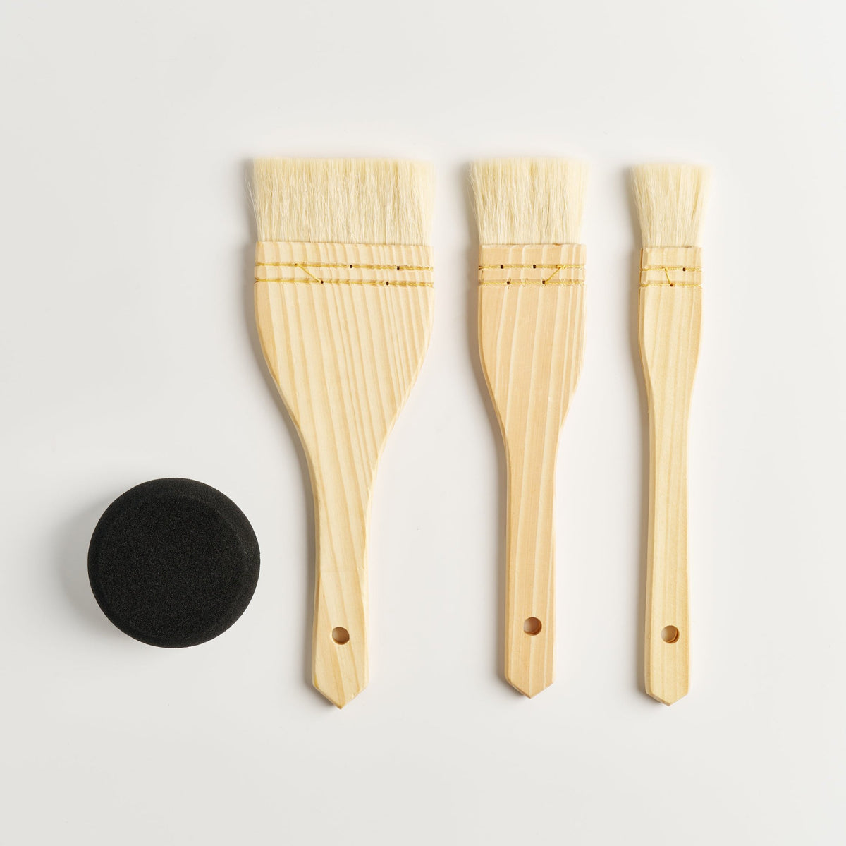 A set of 3 Flazt hake brushes and a small round black sponge