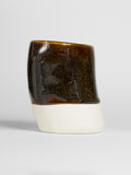 Golden Honey on a thrown cylinder of white clay, glossy dark brown shot through with gold speckle