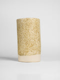 Speckle Matt on a thrown cylinder, warm oatmeal matt densely flecked with dark specks over a pale foot
