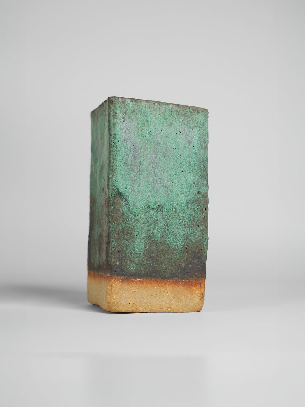 Malachite Green on a square test block, soft green over a dark base and a toasted clay foot