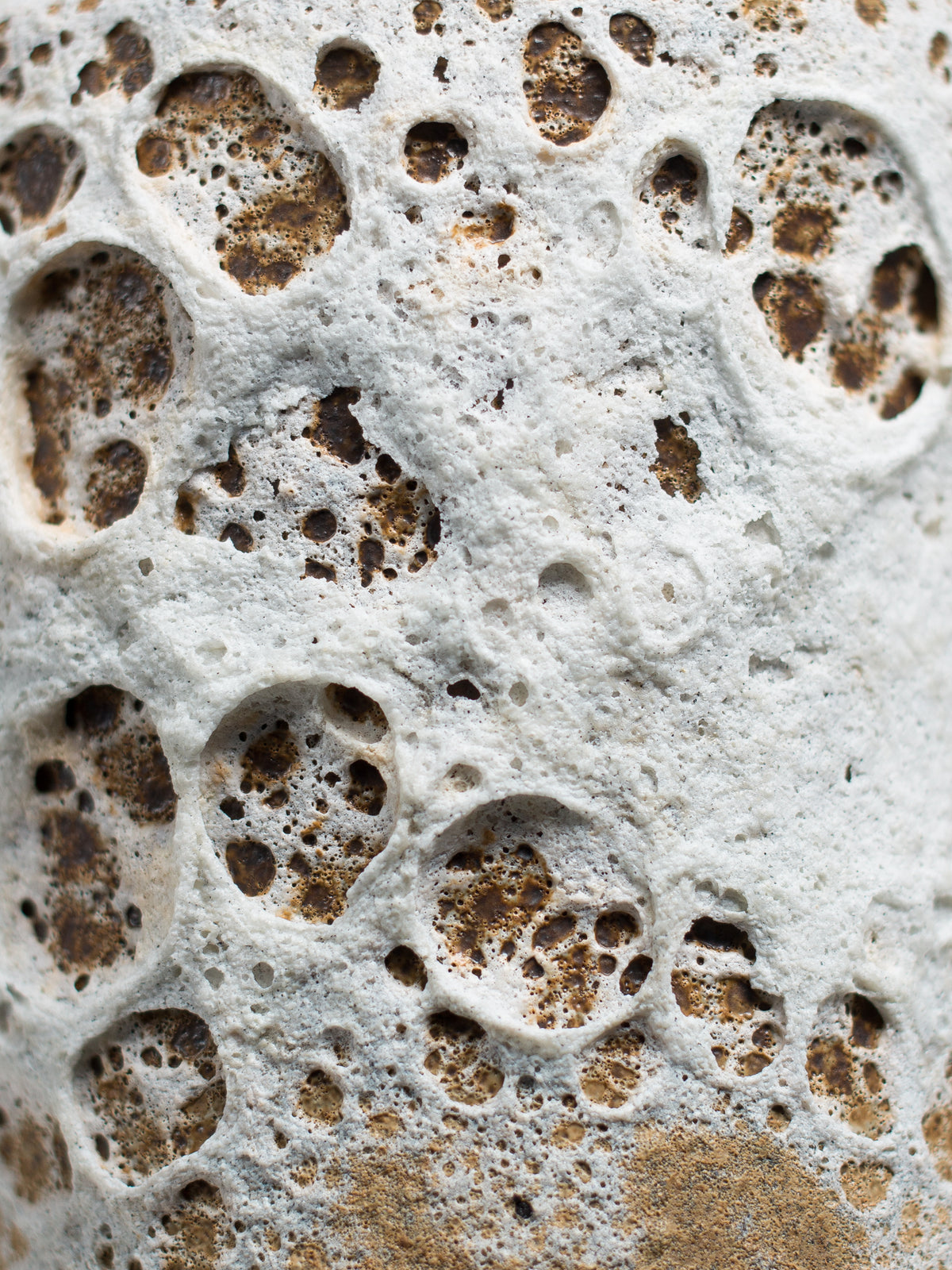 Close-up of White Lava glaze showing dramatic textural variations ideal for oxidation firing and statement ceramic pieces.