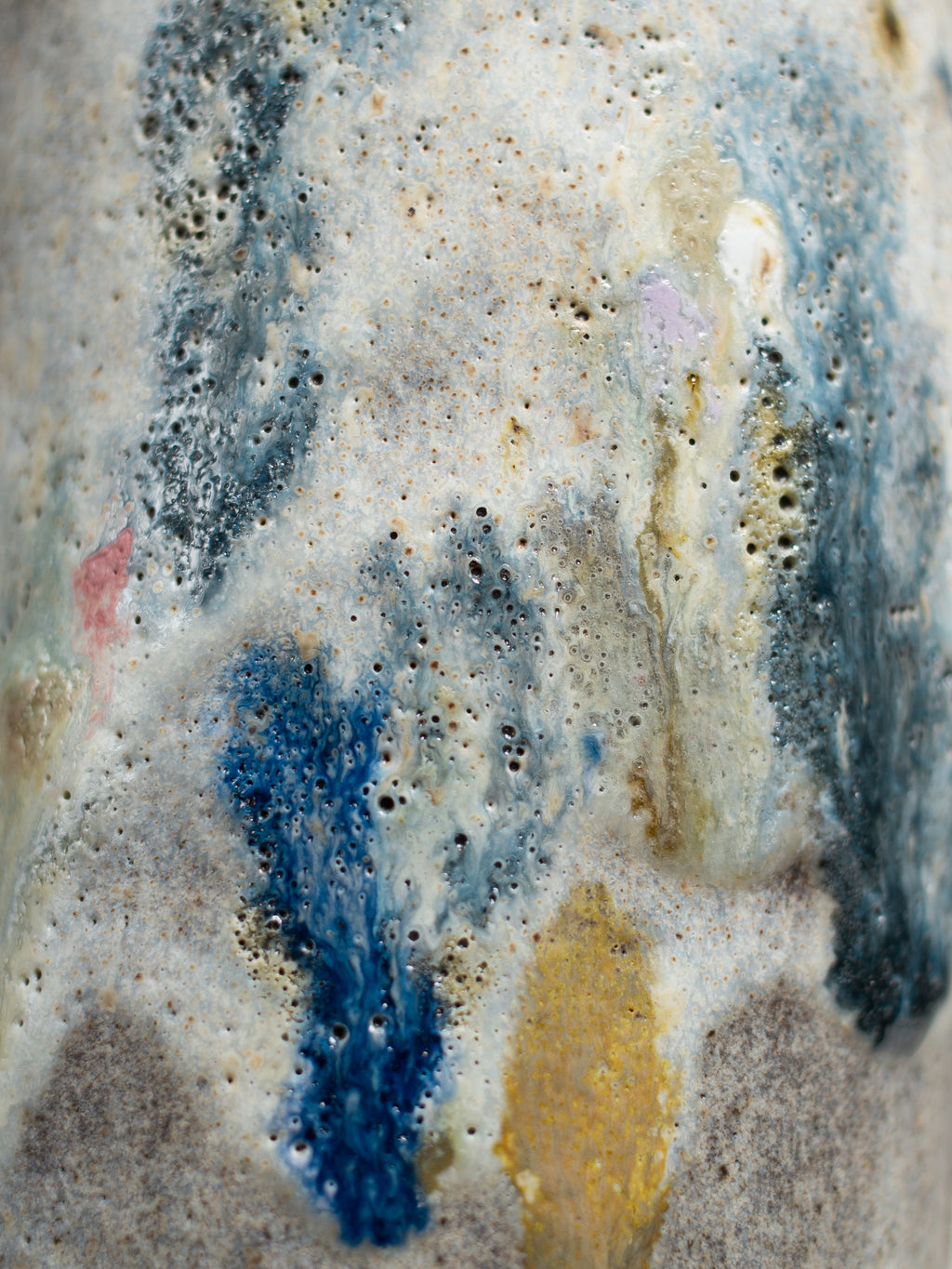 Close up of Recycled Glaze Sprinkle, mottled blue and ochre over white