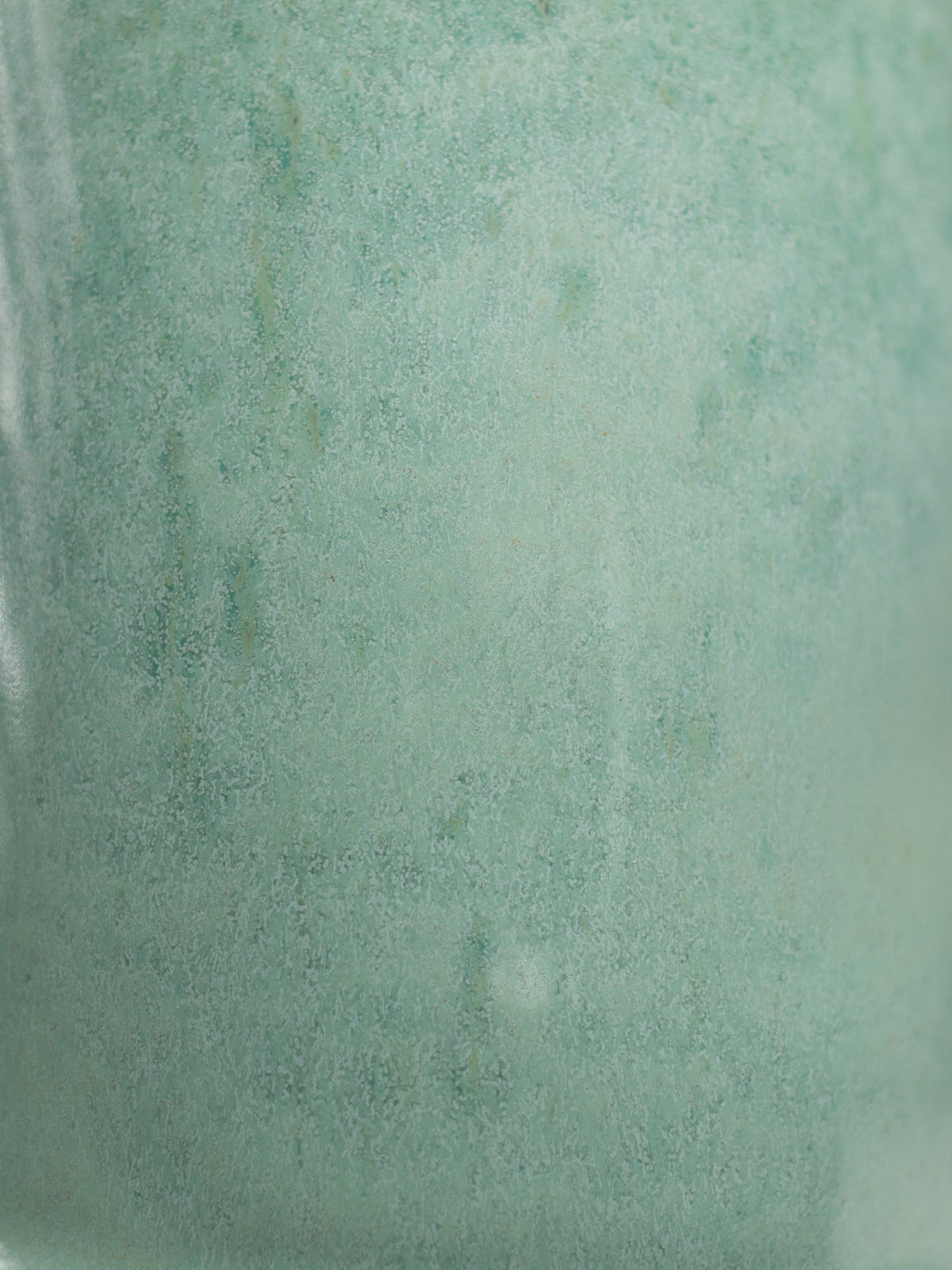 Close up of Jade Turquoise Gloss, a soft green glossy surface
