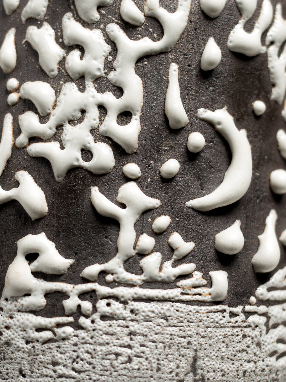 Close up of Crawl Textured White, thick white glaze crawled over a dark body
