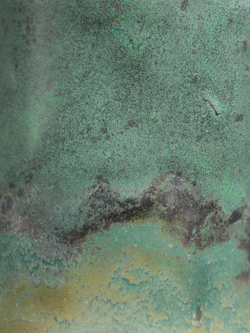 Close view of the Malachite Green surface, speckled matt green shading into brown and ochre