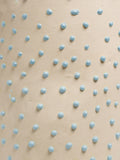 Close up of Light Blue Liquid Gloop, blue droplets across a cream surface