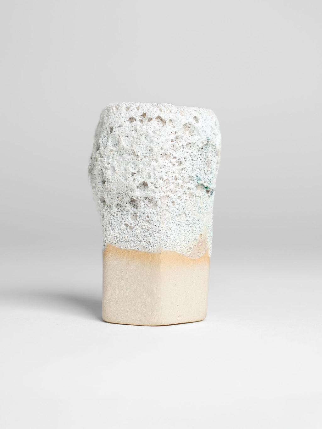White Lava ceramic glaze applied to a surface, showcasing its volcanic-inspired textures and relief effects.