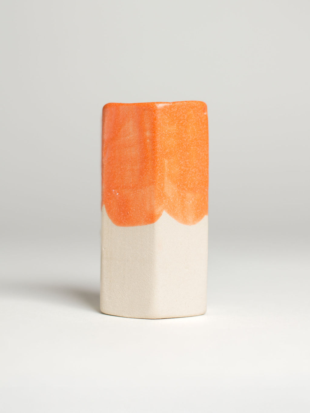 Orange Pastel Dreams test tile on pale clay, orange ending in a soft scalloped line