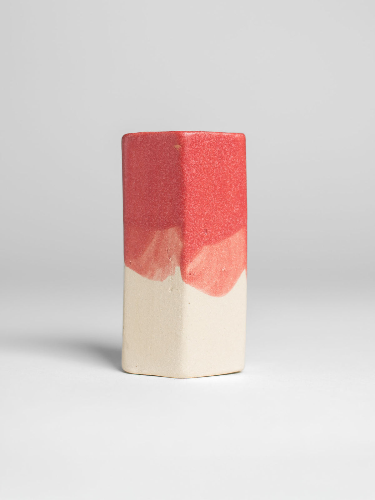 Hot Red Pastel Dreams glaze on a test tile, red matt over bare clay