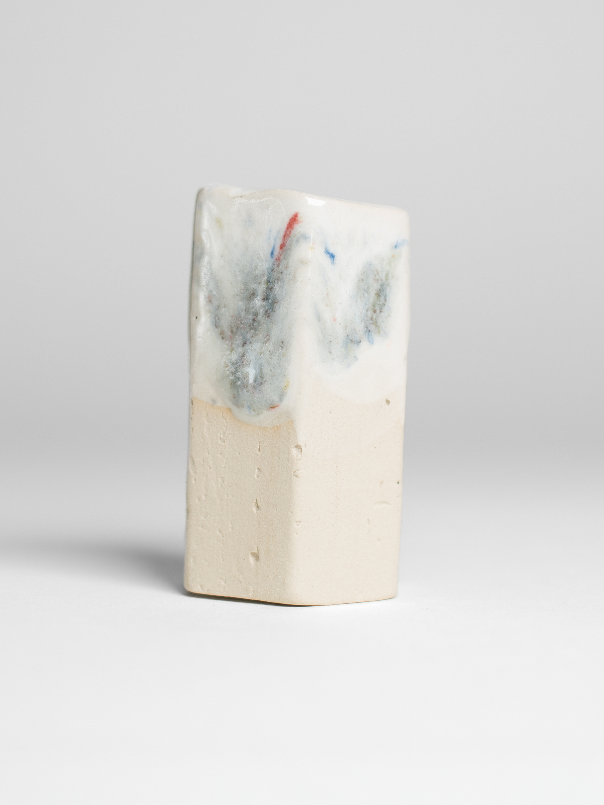 Recycled Glaze Sprinkle on a white test tile, scattered blue flecks
