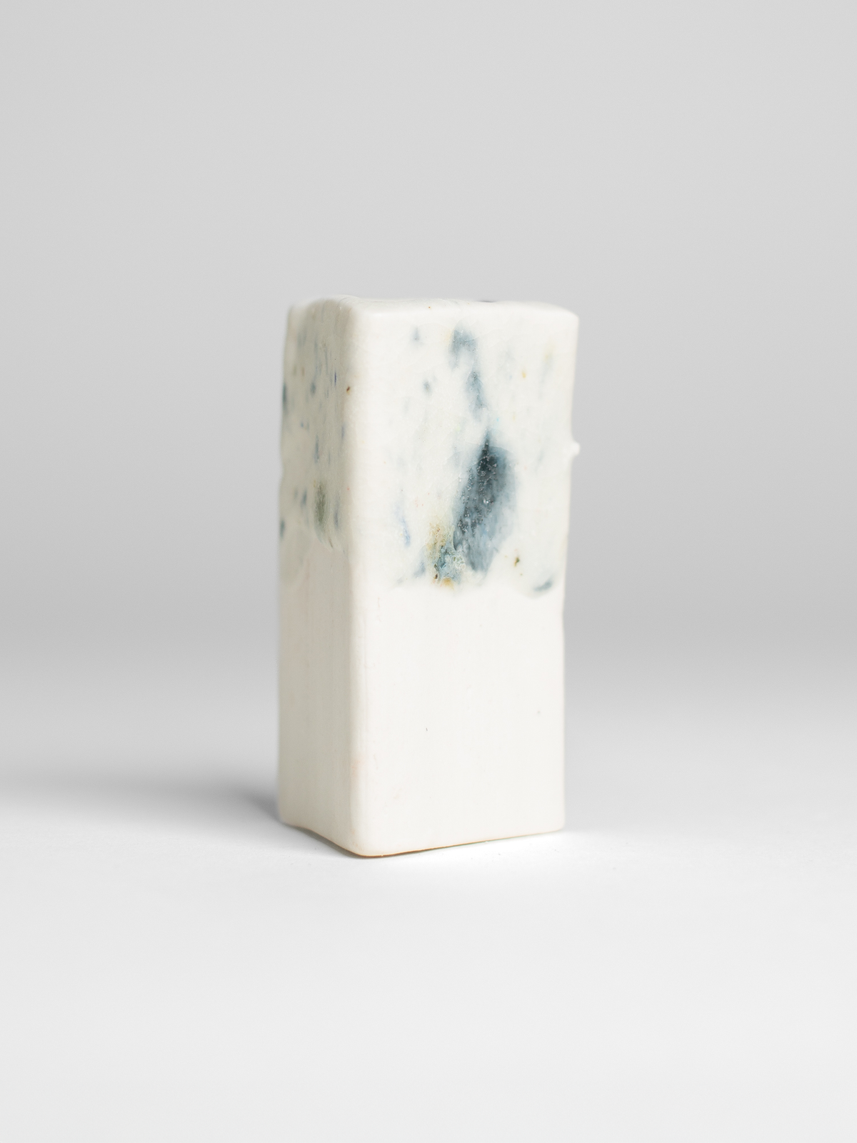 Recycled Glaze Sprinkle on a test tile, blue and green flecks over white