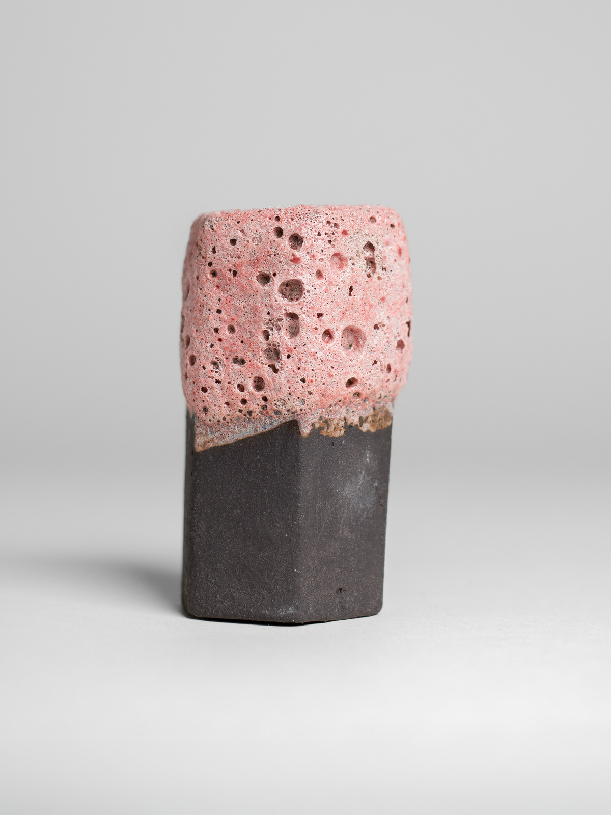 Ceramic piece featuring Pink Lava glaze, with pronounced volcanic textures and tonal shifts based on firing conditions.
