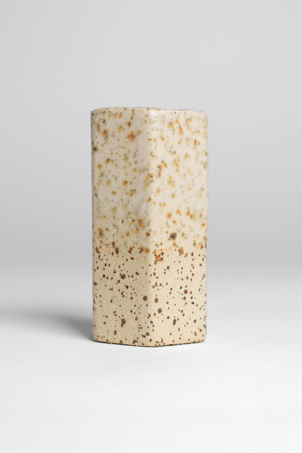Milky Matt White test tile on speckled clay, thin translucent white letting the iron spots read through