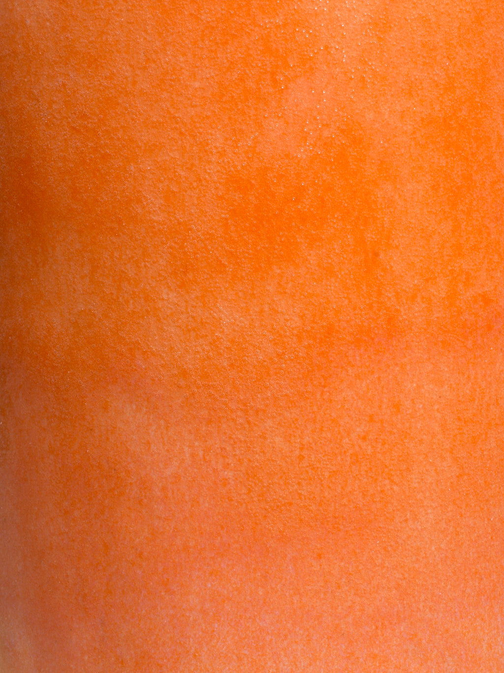 Peach glossy pottery glaze close up