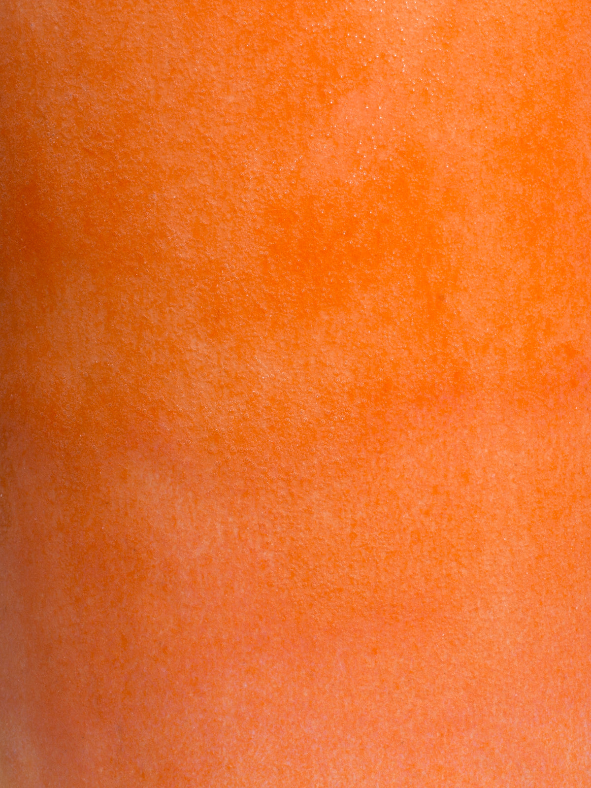 Peach glossy pottery glaze close up