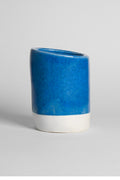 Frosty Blue on a thrown cup of white clay, even glossy mid-blue with a crisp line above the raw foot