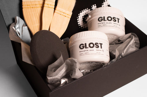 Glaze hamper contents, jars of glaze, a brush and a card in a black box