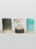 The three lava glazes side by side on thrown cylinders, Lichen green, White Lava and Sea Foam turquoise