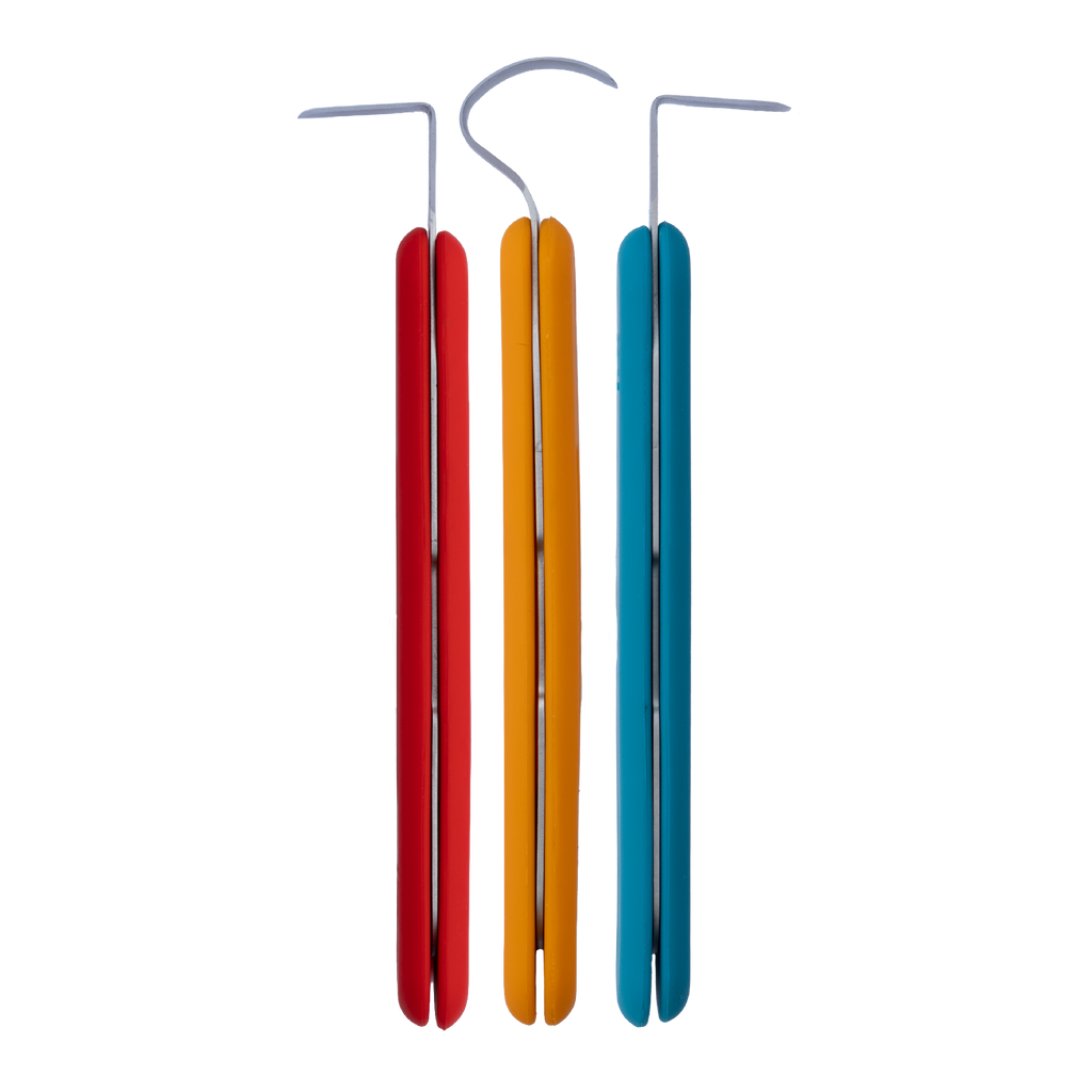 The BuschKraft Forge trimming starter kit laid out, three tools with coloured silicone grips and stainless steel blades.
