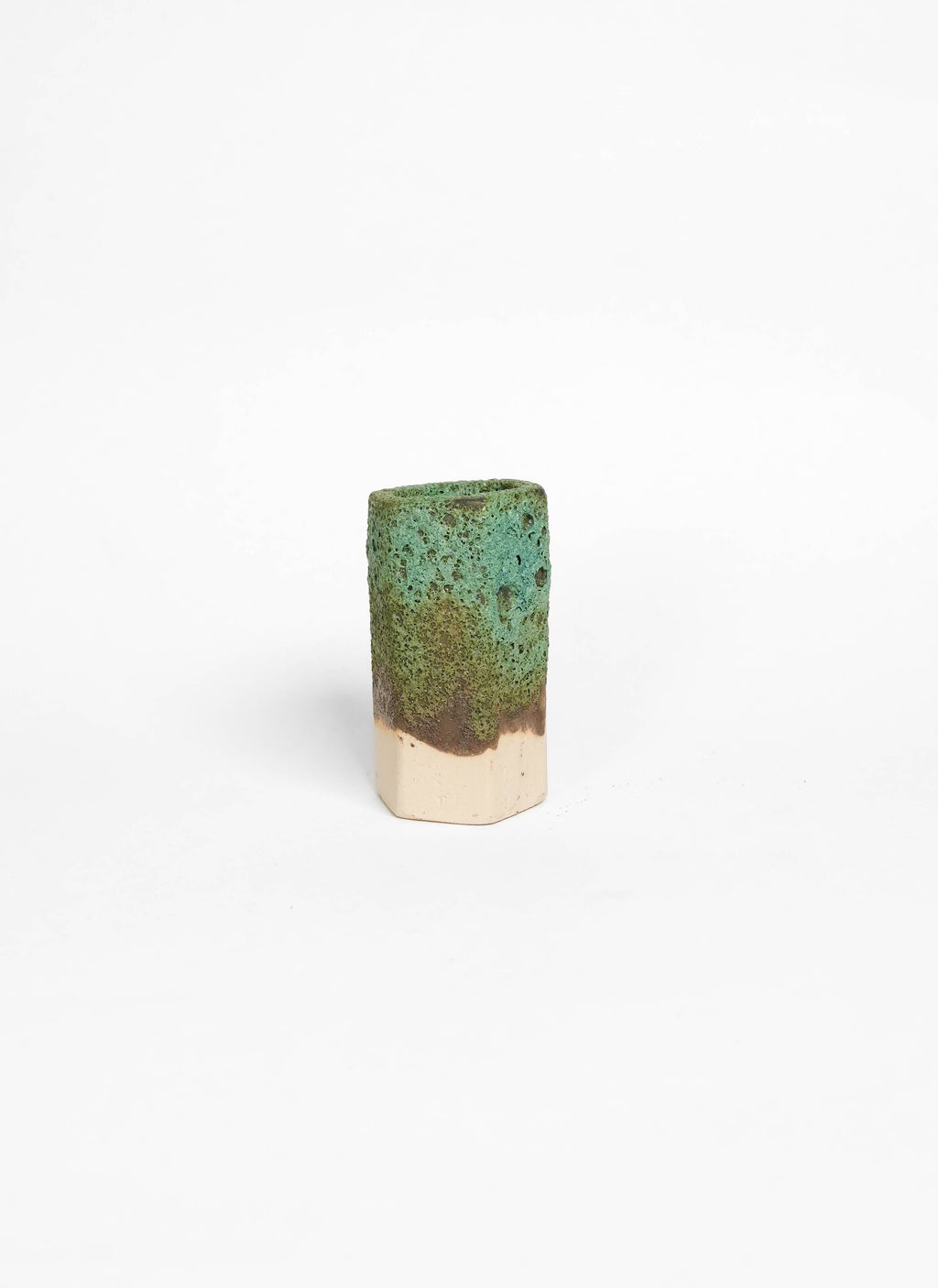 Cylindrical ceramic object with green textural glaze on white stoneware