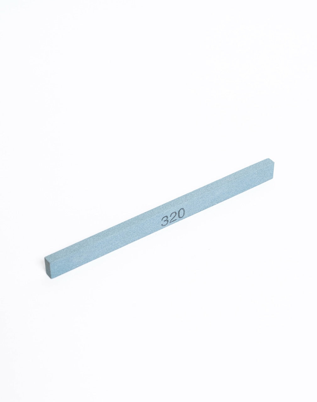 A 320 grit whetstone stick laid flat, the grit number printed along its face.