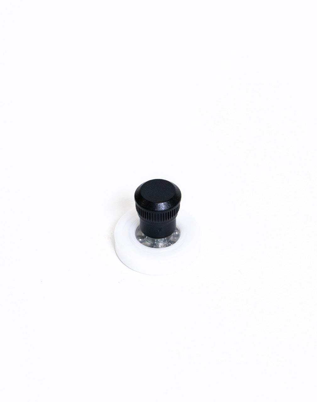 Black knurled spinner knob on a white nylon disc, chrome bearing visible between knob and base