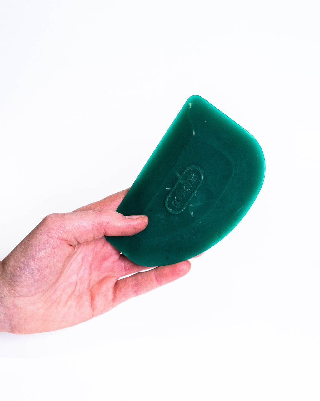 Hand holding the green plastic rib, showing its size against the fingers