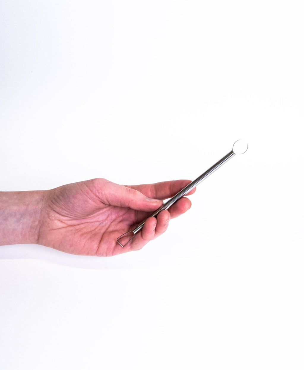Hand holding a double-ended loop tool, round ring at the top and a trapezoid loop below