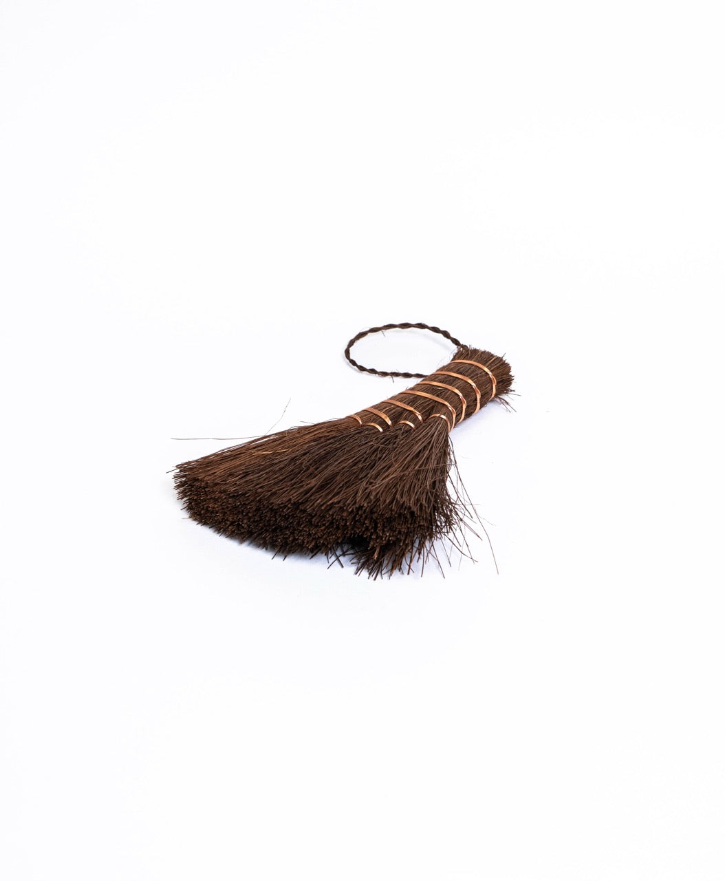 Wide fan palm fibre brush bound with copper wire, with a plaited hanging loop