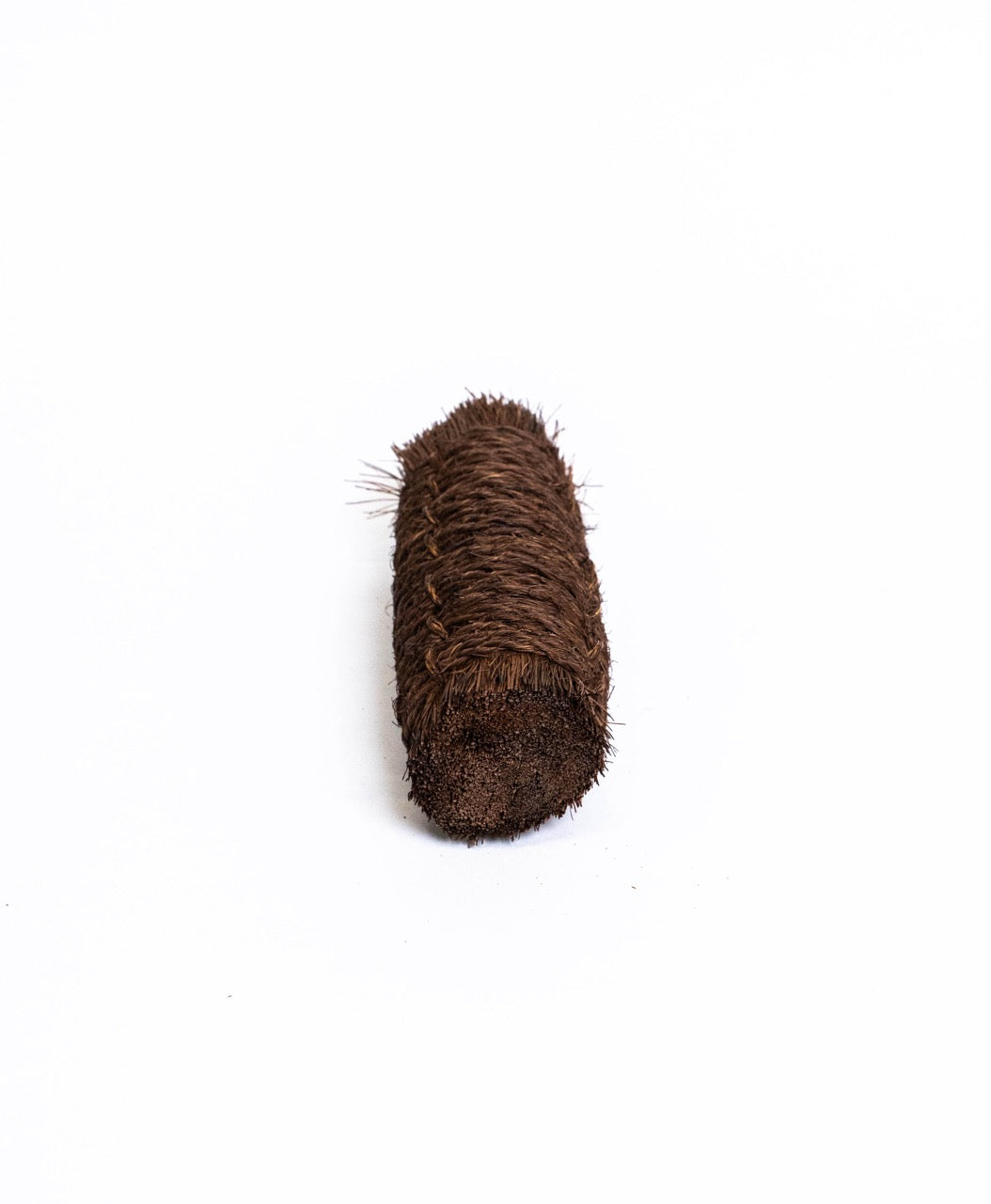 Small block-shaped palm fibre scrubbing brush, seen end on