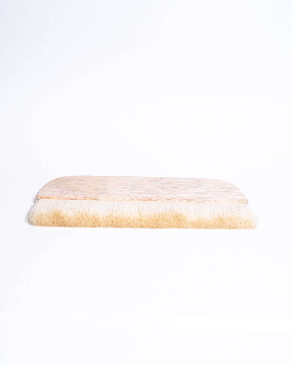 Wide hake brush laid flat, bristles fanned evenly along the wooden handle