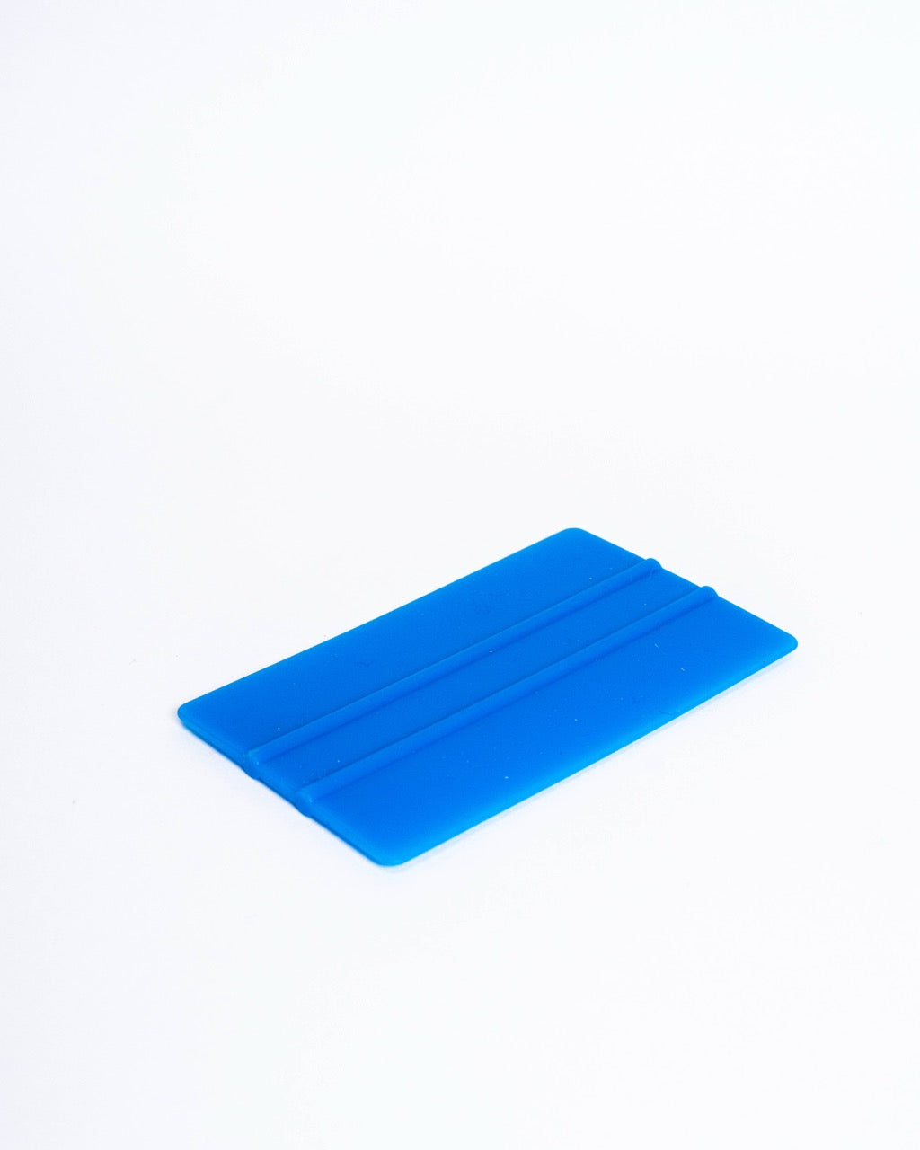 Blue plastic squeegee rib, rectangular with two moulded ridges, lying flat