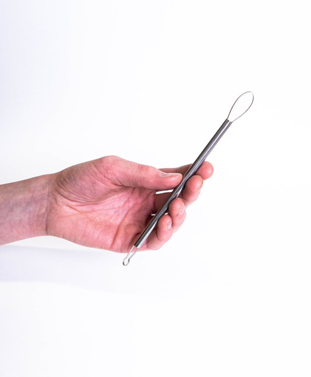 Hand holding a double-ended loop tool, large teardrop loop at the top and a small round loop below