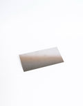 Stainless steel rib, rectangle with a combed row of fine teeth along one long edge