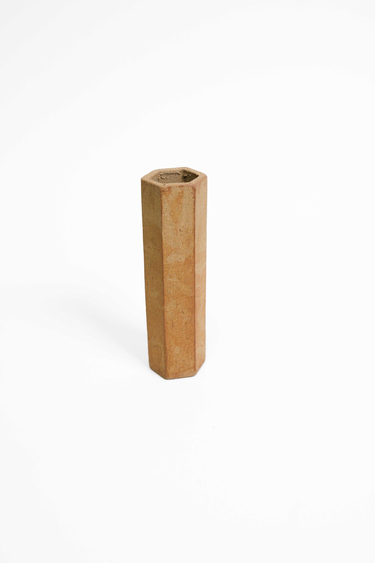 A tall faceted vessel in Rich Toasted fired high, mottled tan and ochre