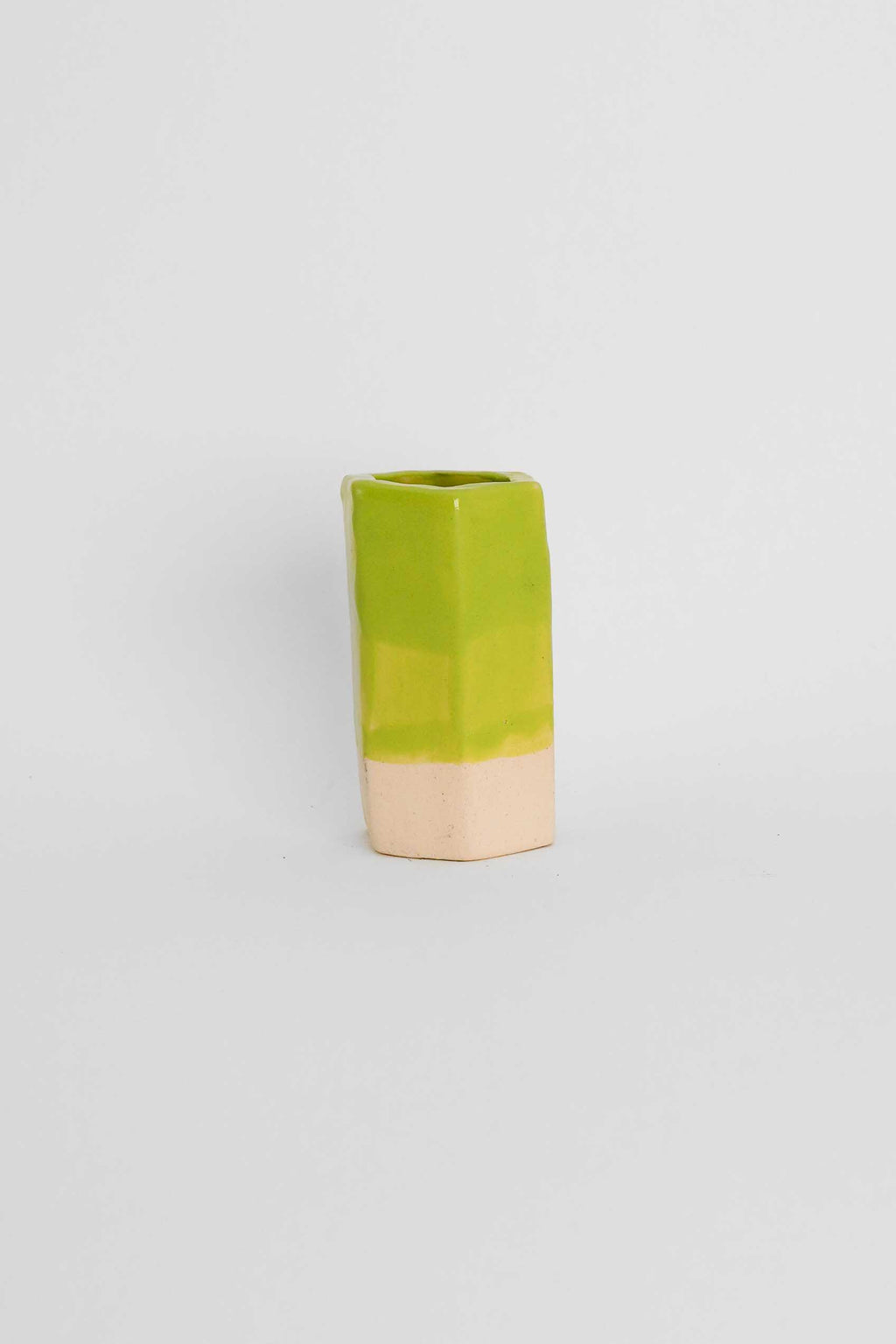 Fired sample tile showing Lime Green ceramic stain by GLOST Glaze in a transparent glaze on white stoneware