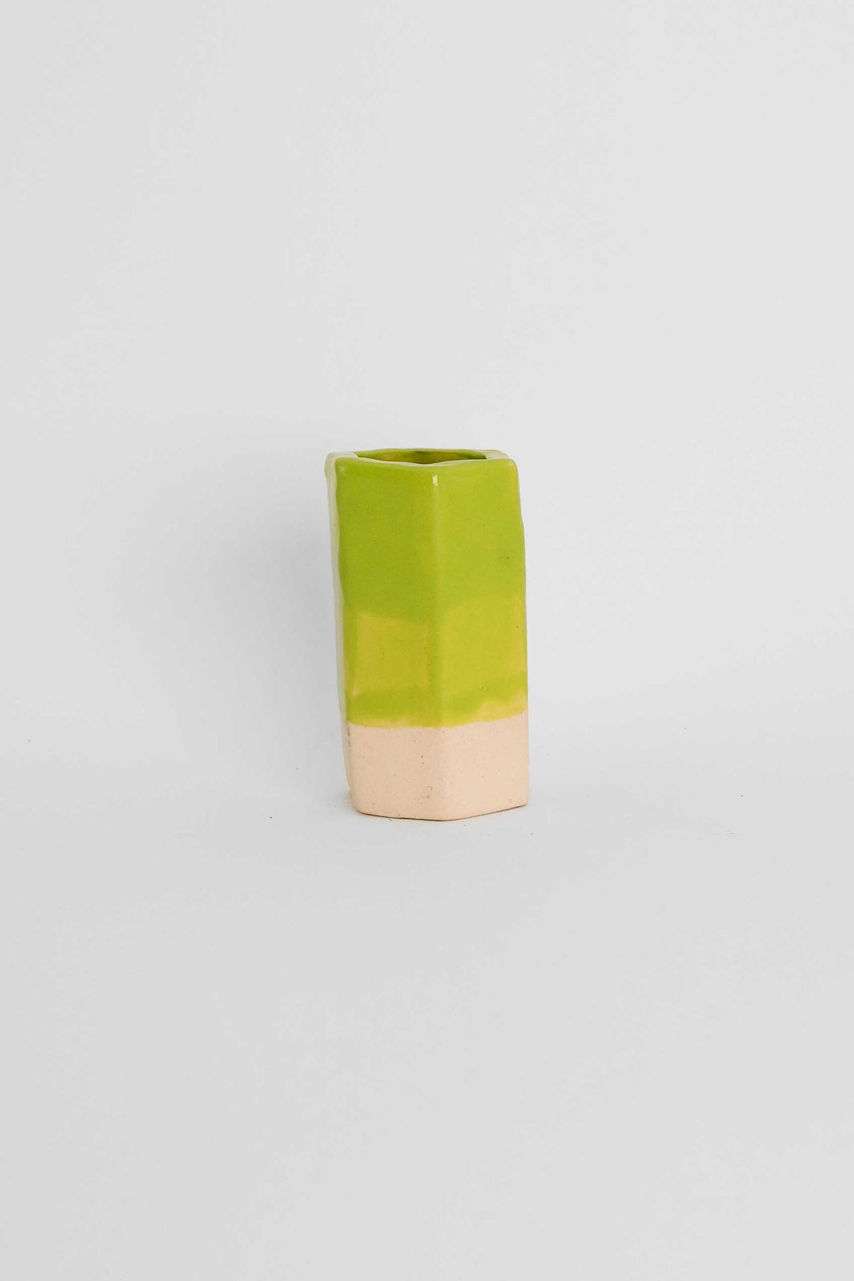 Fired sample tile showing Lime Green ceramic stain by GLOST Glaze in a transparent glaze on white stoneware