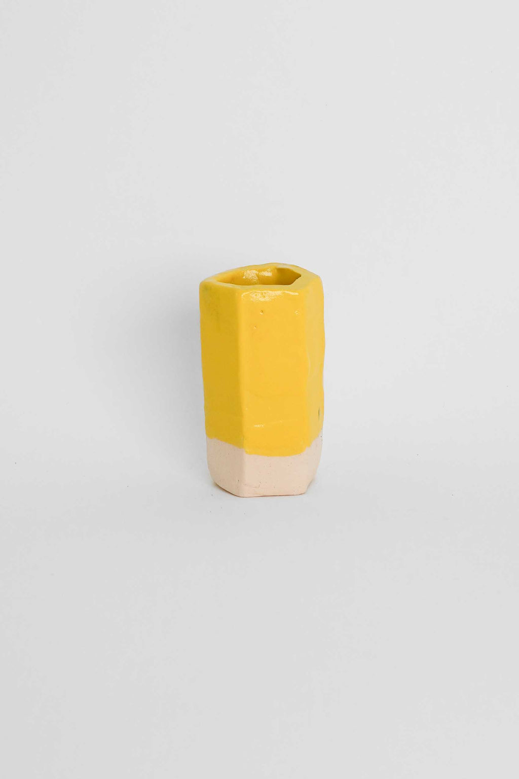 Yellow ceramic stain in a glaze on a fired test cylinder