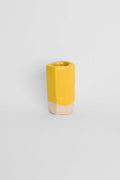 Yellow ceramic stain in a glaze on a fired test cylinder