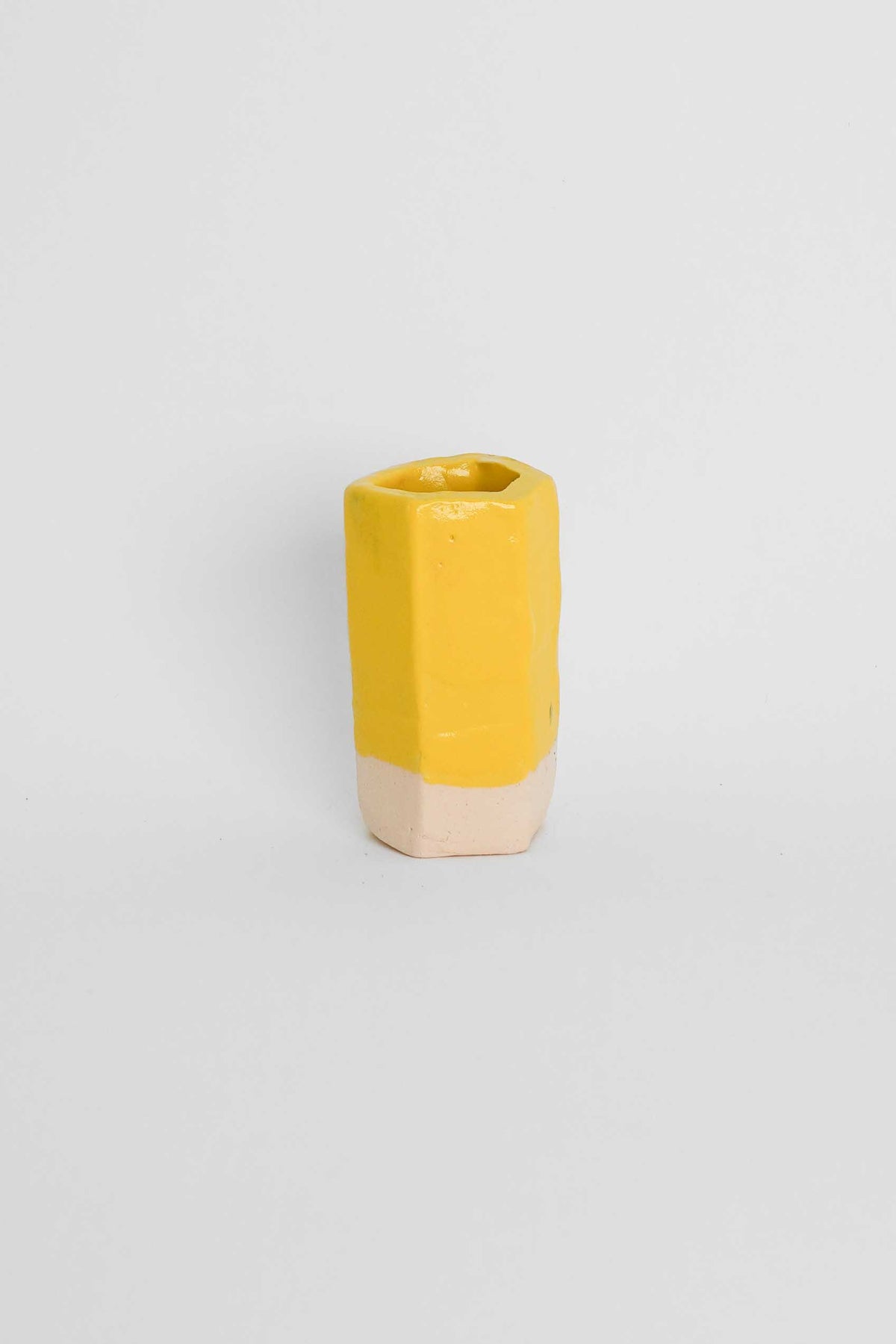 Yellow ceramic stain in a glaze on a fired test cylinder