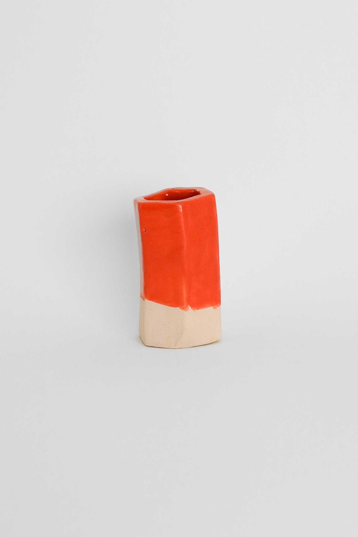 Fired sample tile showing Orange ceramic stain by GLOST Glaze in a transparent glaze on white stoneware