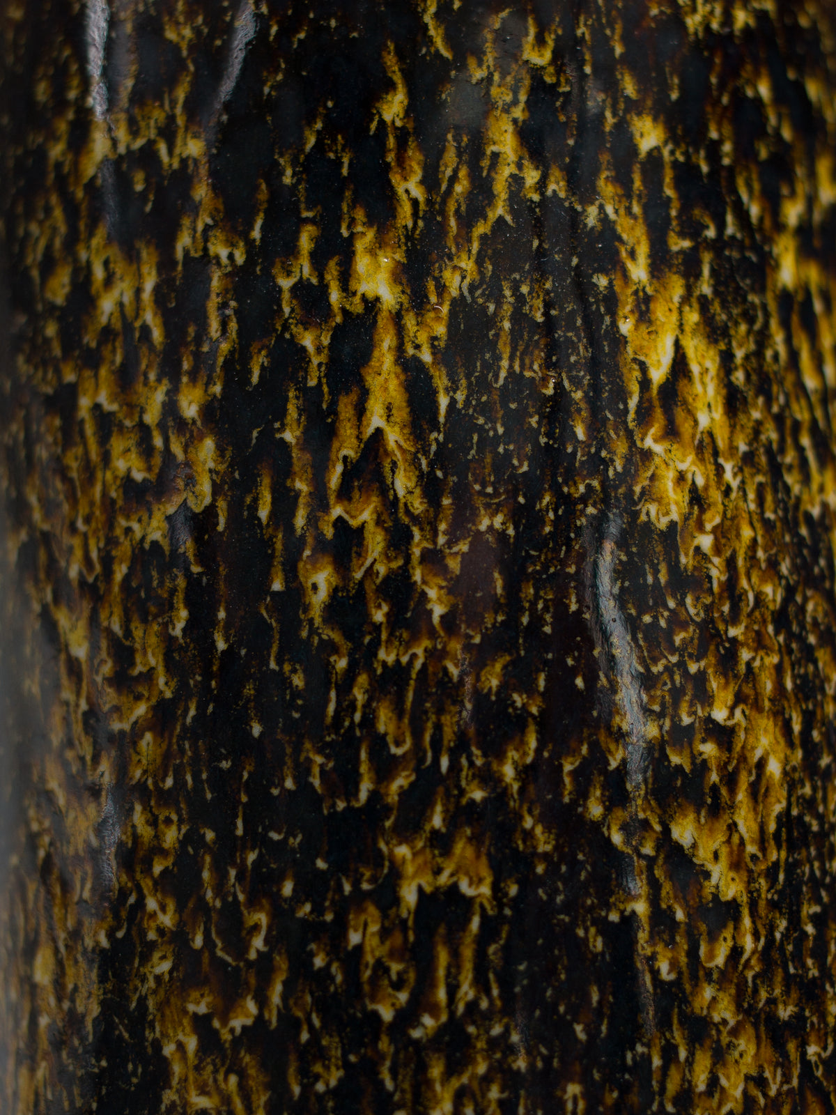A glazed cup held in the hand, the interior lined with a smooth glaze